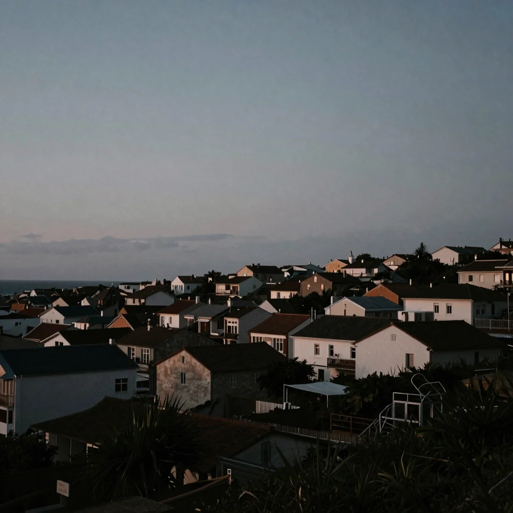 Wide panoramic view of a coastal town at twilight, overcast sky, subtle architectural shadows, moody film photography.